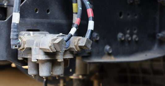 A close-up view of a truck's push-pull air valves and hoses, connected to the entire vehicle's air brake system.